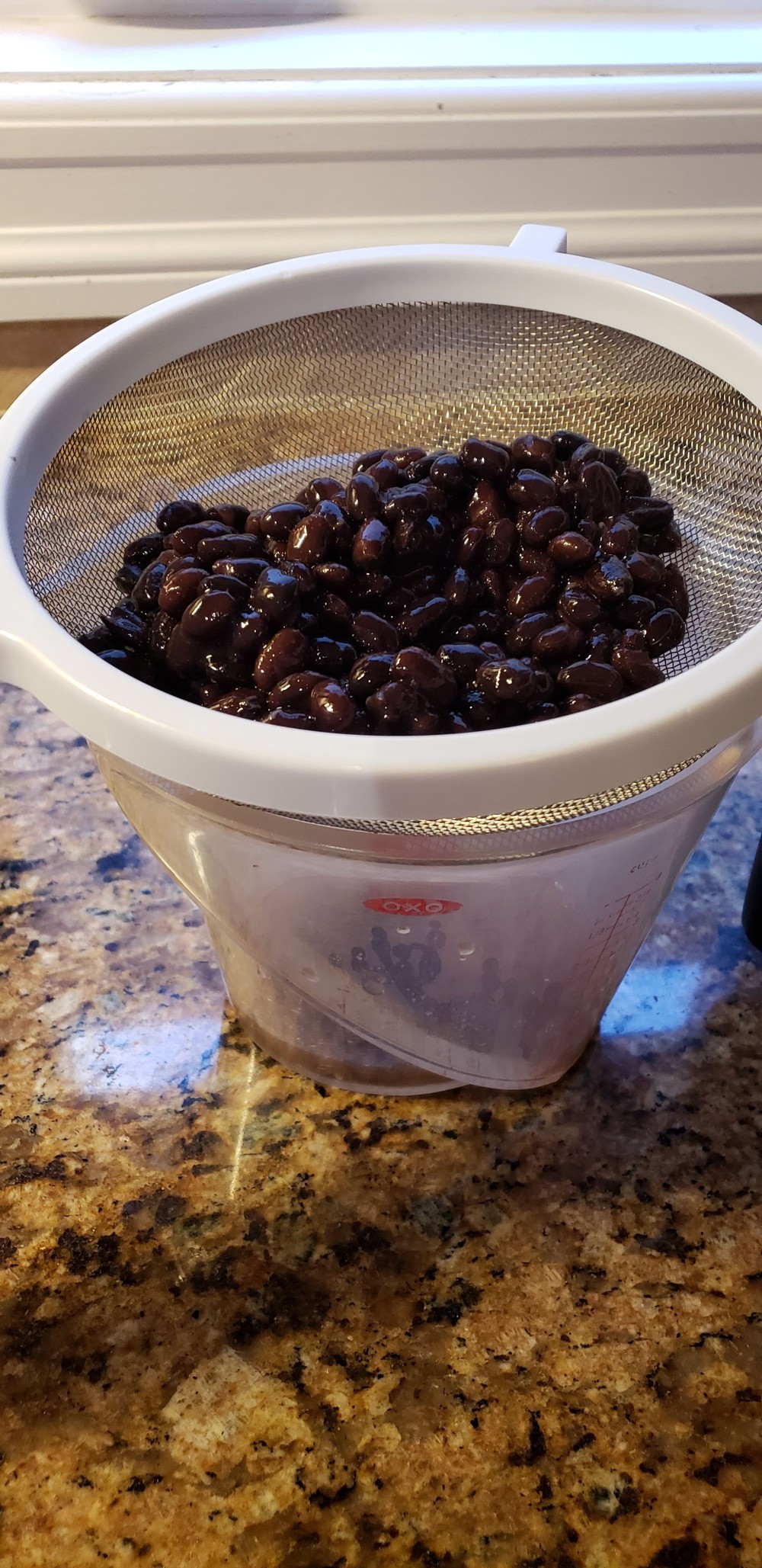 straining black beans for moros