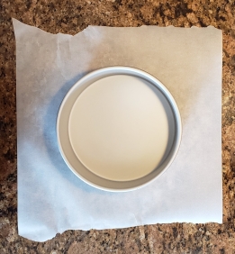 Cut a square piece of parchment paper that is larger than the pan.
